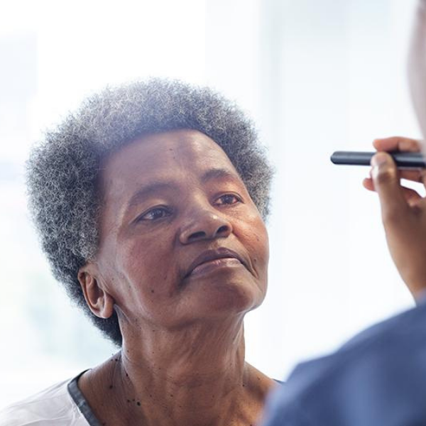 Woman getting light shown in her eyes.