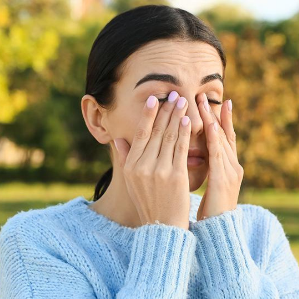 Woman rubbing her sore eyes.