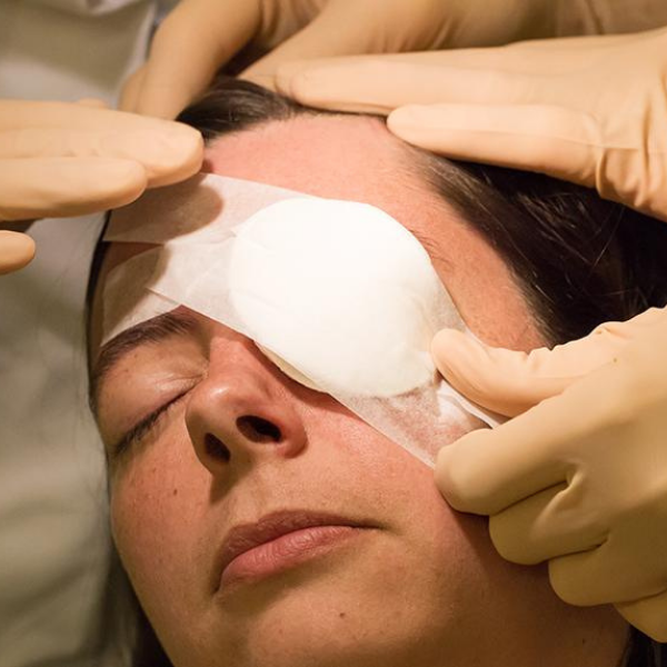 Woman getting an eye cover after surgery.