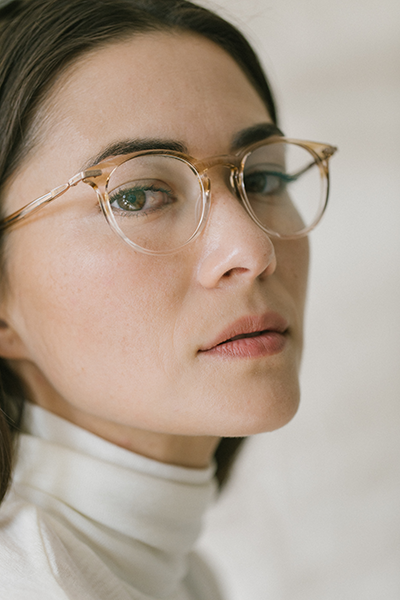 Woman with black hair models Barton Perraira Capote glasses.