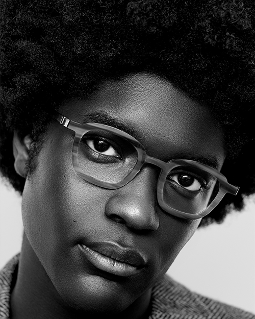 A black man models Lindberg glasses.