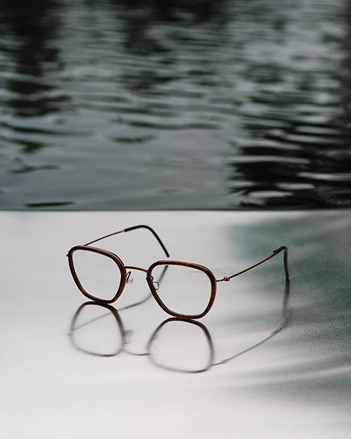 Lindberg glasses next to water.